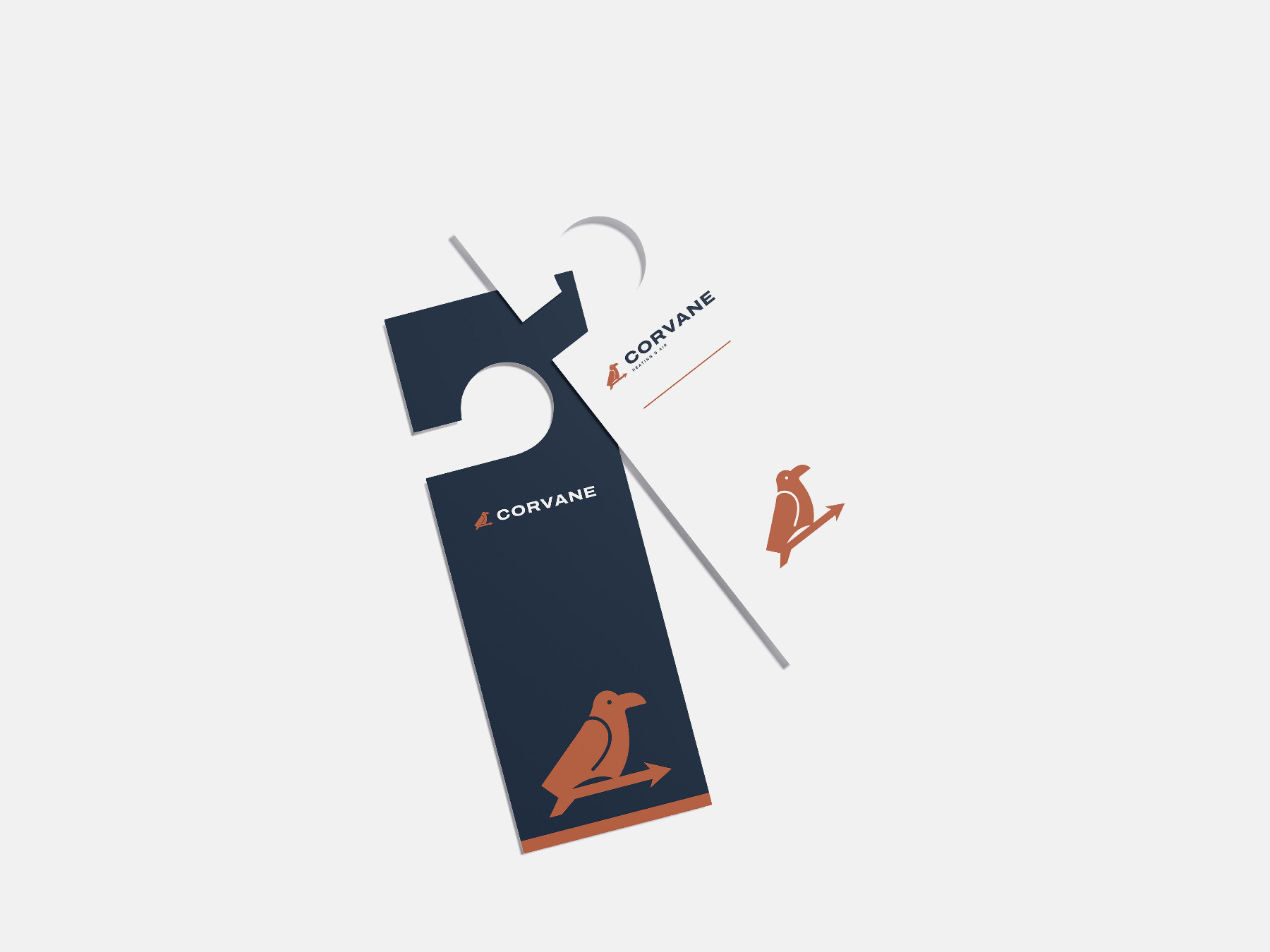 Concept brand: Corvane Heating & Air (fictional). Corvane door hangers we designed, navy and white, on a light grey surface.